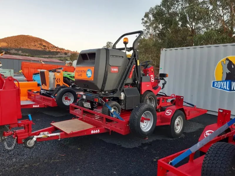 Mowers loaded on trailers ready for site work