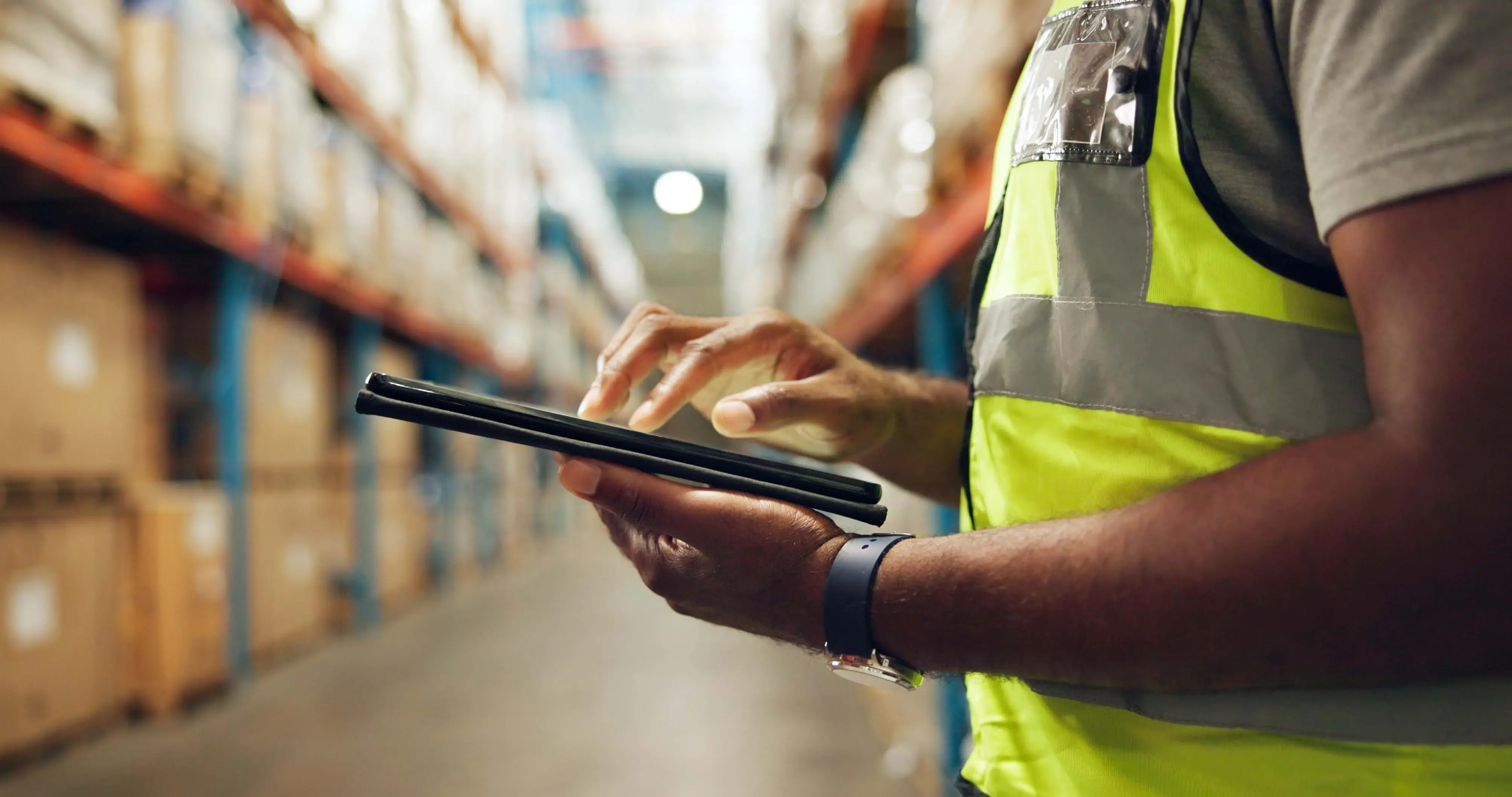 Person in a warehouse using a tablet