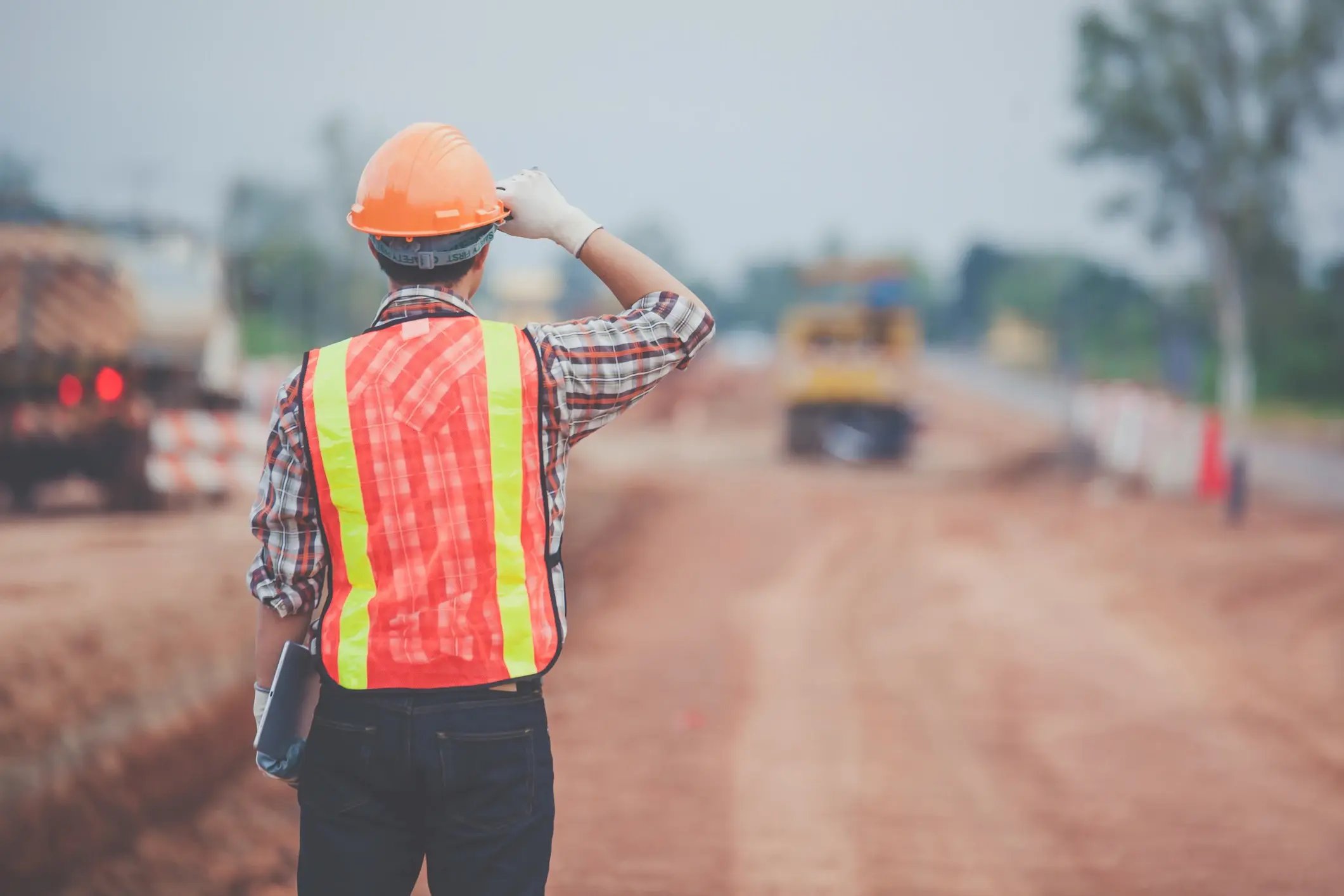 Person on a building site looking out at the work happening