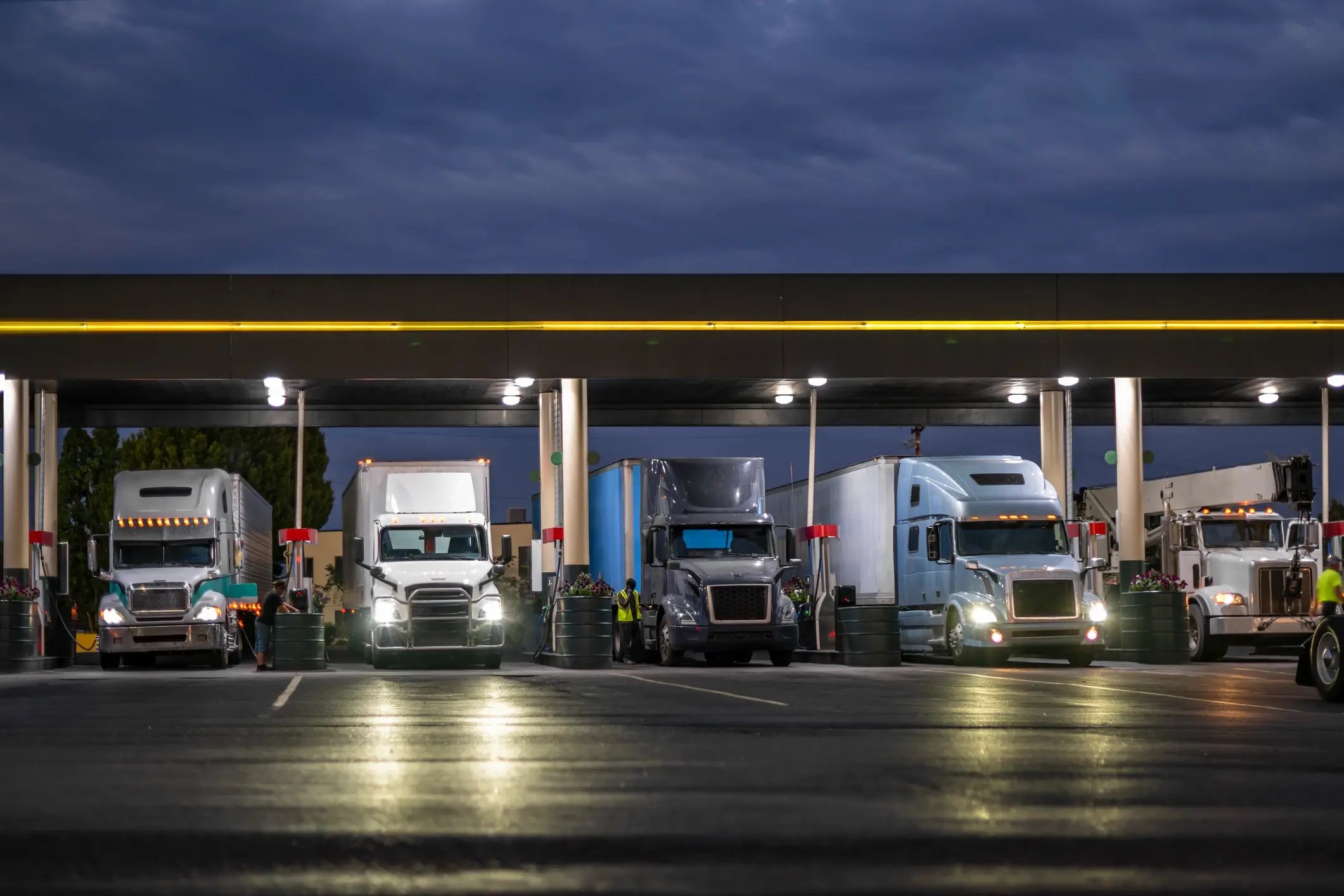 Trucks at a truck stop at night, lined up