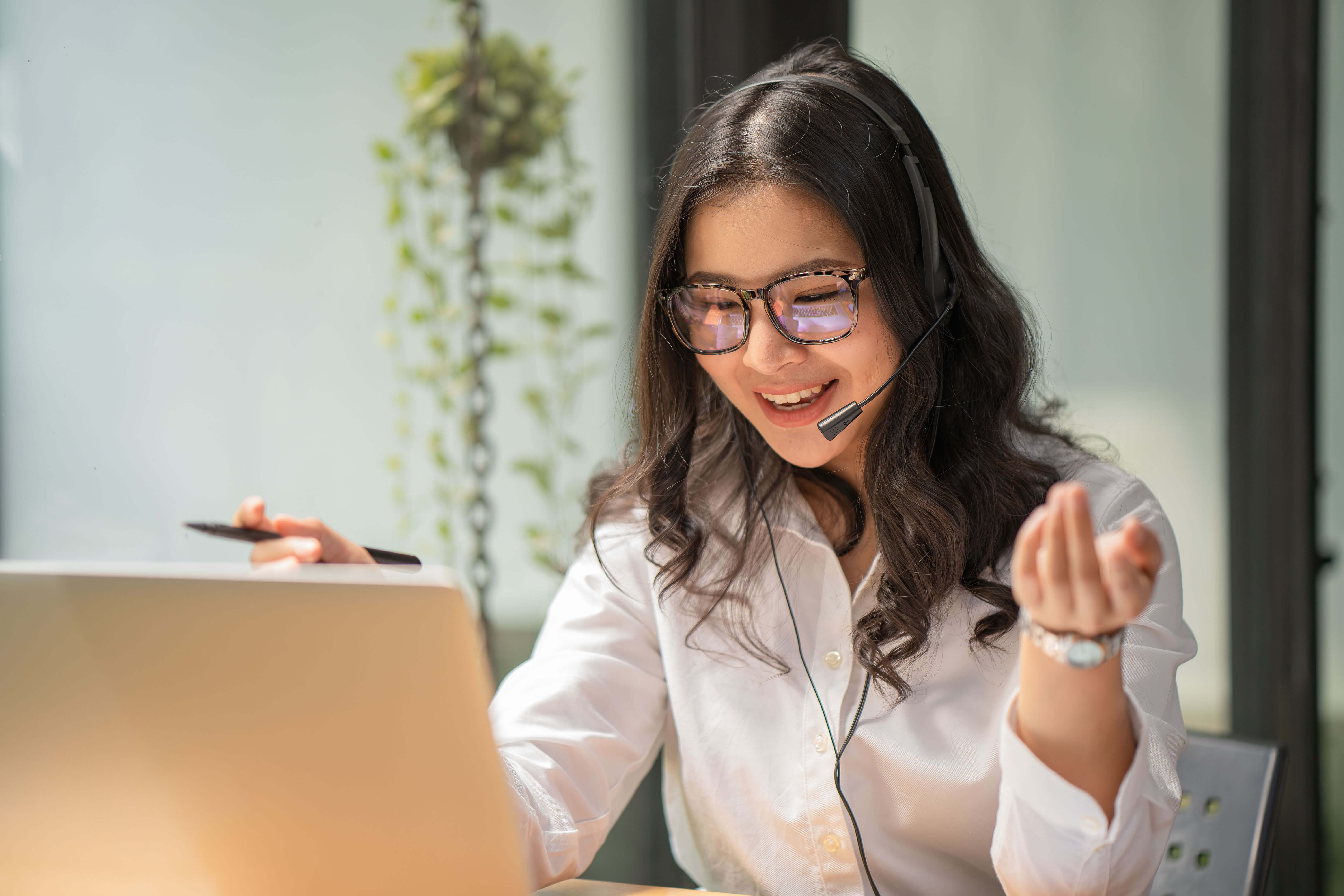 woman-in-white-shirt-using-headphone-&-computer