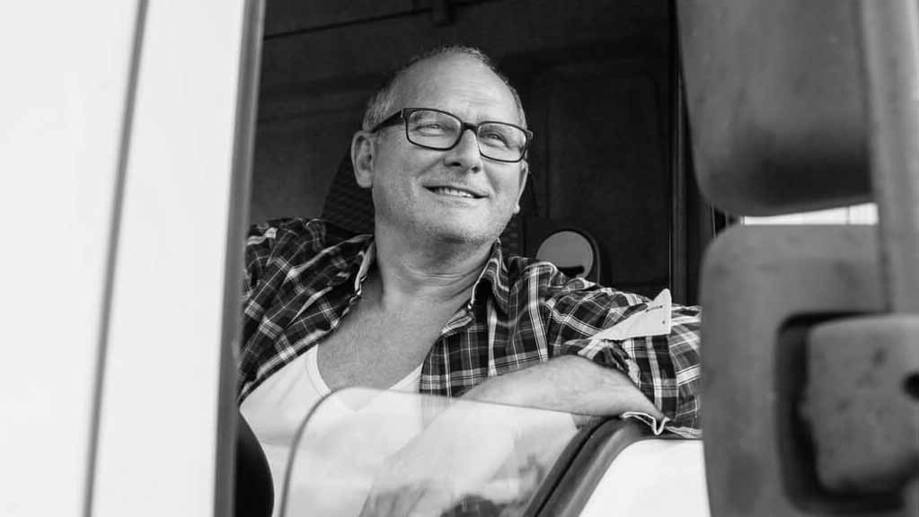 Man smiling from truck window_BW